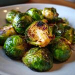 Close-up of perfectly crispy Air Fryer Brussels Sprouts, showing their vibrant green color and caramelized edges.