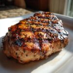 Close-up of golden brown, crispy air fryer coconut shrimp coated in shredded coconut and spices.