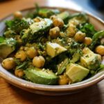 Close-up of a vibrant chickpea and avocado salad in a bowl, featuring creamy avocado chunks and tender chickpeas.