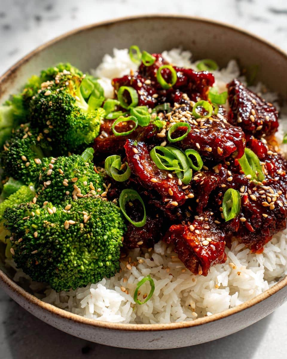 Close-up of Easy Korean Gochujang Beef Bowls with rice, broccoli, and green onions.