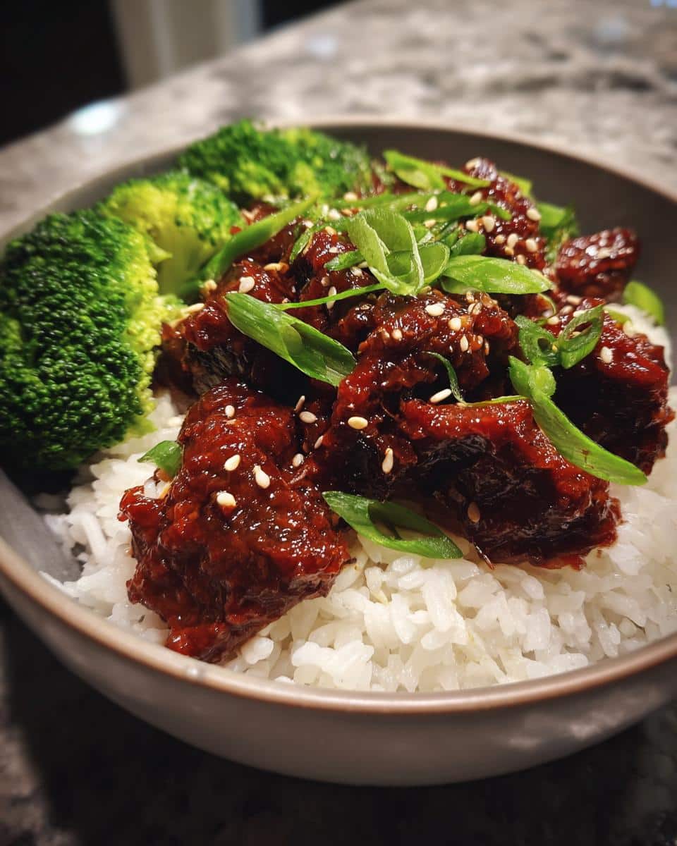 Close-up of Easy Korean Gochujang Beef Bowls with rice, broccoli, and sesame seeds.