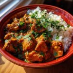 A close-up of Quick & Easy Homemade Butter Chicken served with fluffy white rice and garnished with fresh cilantro.