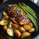 A delicious one-pan roasted chicken with potatoes and asparagus, perfect for easy weeknight dinners.