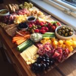 A vibrant and abundant charcuterie board perfect for a Girl Dinner Recipe, featuring cheeses, meats, fruits, and crackers.