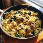 A delicious one pan garlic parmesan chicken pasta with spinach, served directly in the skillet.