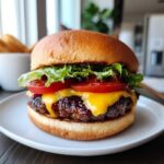 Delicious Air Fryer Burger on a bun with cheese, tomato, and lettuce. Ready to eat!