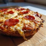 Close-up of a pepperoni Air Fryer Pizza, showcasing the melted cheese and crispy crust.