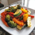 A colorful plate of air fryer vegetables, including broccoli, zucchini, and bell peppers, cooked to perfection.