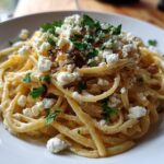 A plate of Caramelized onion feta pasta, topped with fresh parsley. Creamy and delicious.