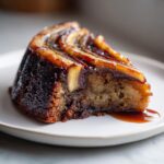 A slice of Chocolate Banana Upside-Down Cake on a plate, showcasing the caramelized banana topping.