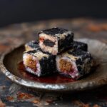 A stack of Oreo sushi pieces on a plate, featuring Oreo filling and a seaweed wrap.