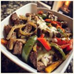 A close-up of a Philly Cheesesteak Bowl filled with tender steak, sautéed onions, and colorful bell peppers topped with melted cheese.
