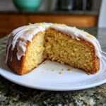 A delicious iced rat cake with a slice cut out, revealing the cake's texture.