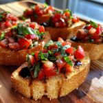 Close-up of bruschetta appetizers on a wooden board, topped with fresh tomatoes, basil, and balsamic glaze.