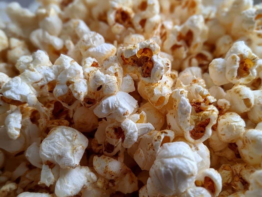 A close-up shot of freshly made Honey Popcorn, showing the texture and golden honey coating.