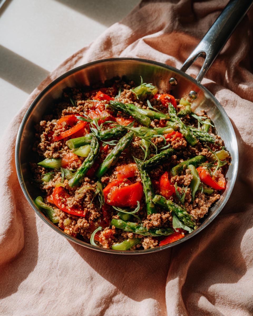 Skillet with ground meat, asparagus, and red peppers, a Makayla Thomas fit recipes dish.