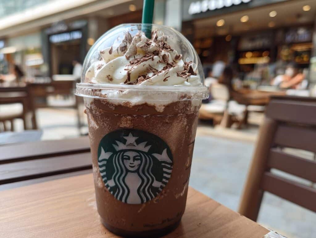Starbucks drink with whipped cream and chocolate shavings, representing a Milo Ice Latte Hack.