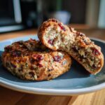 Two protein bagels on a blue plate, one bagel is cut in half showing the inside texture.