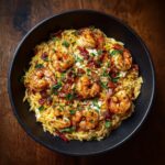 Overhead shot of a bowl of Shrimp Orzo with shrimp, bacon, and parsley.