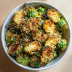 Overhead view of crispy roasted brussels sprouts with panko in a serving bowl.