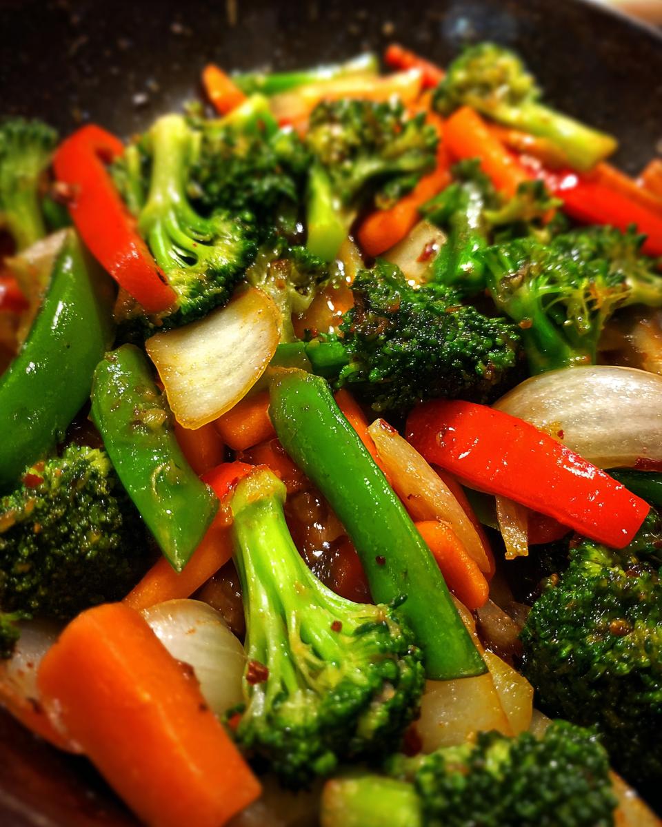 Close-up of Broccoli Mushroom Stir Fry with broccoli, carrots, onions, and red peppers.