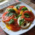 A vibrant Caprese Salad Tomato Mozzarella Basil dish with fresh basil leaves and balsamic glaze.