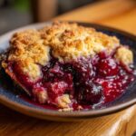 A slice of homemade cherry cobbler with a golden crust and juicy cherry filling. Perfect cherry cobbler recipe.