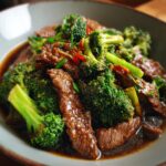 Close-up of Chinese Beef Broccoli in a bowl, featuring tender beef and vibrant green broccoli.
