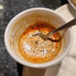 A small bowl of 5-Minute Copycat Smash Burger Sauce with a spoon, showing the texture and seasonings.