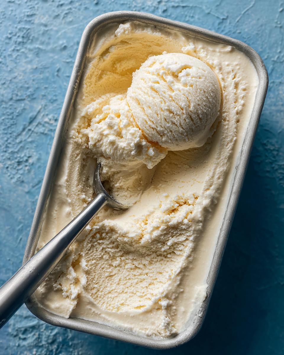 Overhead view of Cottage Cheese Ice Cream Healthy Frozen Treat in a metal container with a scoop.
