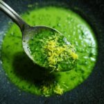 Spoonful of 5-Minute Creamy Cilantro Lime Sauce with lime zest, ready to serve.