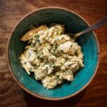 A bowl of Ultimate Creamy Cottage Cheese Chicken Salad with a spoon, ready to be enjoyed.