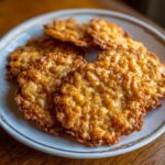 A plate of golden Crispy Edges & Chewy Center Oatmeal Lace Cookies, showcasing their delicate, lacy pattern.