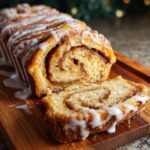 A slice of Easy No-Yeast Cinnamon Roll Cake with icing, showing the cinnamon swirl filling and soft texture.