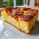 A slice of Fluffy & Crispy Potatoes on a white plate, showcasing its golden-brown crust and soft interior.