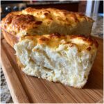 Close-up of a loaf and slice of Ultimate Fluffy Japanese Milk Bread, showcasing its soft, airy texture.