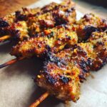 Close-up of grilled Garlic Parmesan Chicken Skewers, showing the crispy texture and wooden skewers.
