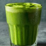 Close-up of a vibrant Green Detox Smoothie in a glass, showcasing its fresh, healthy ingredients.