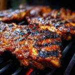 Close-up of Huli Huli Grilled Chicken cooking on a grill, showcasing the caramelized glaze and grill marks.