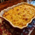 Freshly baked Ultimate Dump and Bake Jiffy Corn Casserole in a decorative baking dish.