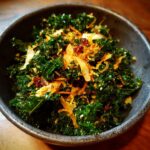 A bowl of vibrant Kale Crunch Salad with crispy toppings and a flavorful dressing.