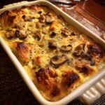 Baked KETO Garlic Mushroom Chicken Casserole in a white dish, golden brown and bubbly.