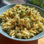 A bowl of Lemon Basil Pasta Salad, featuring spiral pasta, lemon sauce, and fresh basil.