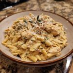 A delicious bowl of Marry Me Chicken Pasta, garnished with parmesan cheese and herbs.