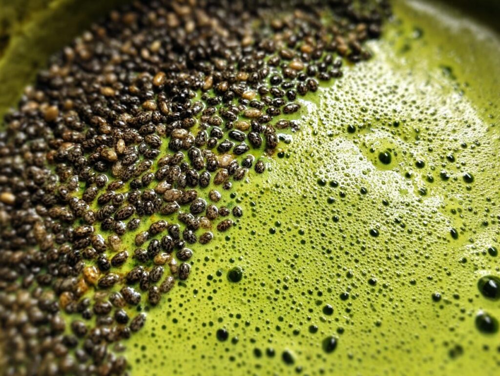 Close-up of creamy vegan matcha chia pudding with chia seeds and a vibrant green matcha base.
